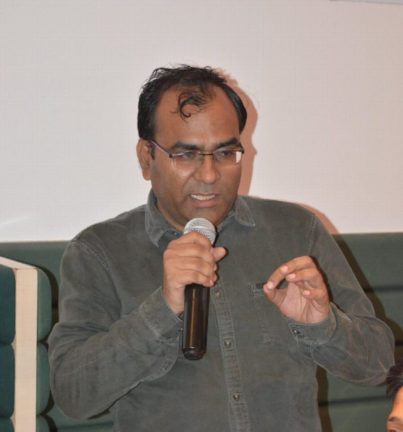 Zareef Ahmed speaking into a microphone